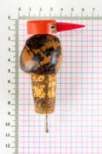 Size demonstration of Tagua Nut bird bottle stopper with pourer