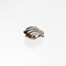 Right side view of a closed oyster shell charm.